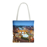 Tote bag with a cityscape design featuring a bridge over water on a white background