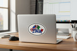 Laptop with 'ITALIA' sticker on a desk with computer and office supplies.