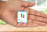 Metal lapel pin shaped like a waving Italian flag with vertical stripes in green, white, and red. Gold-colored edges and flagpole add elegance, while the 1"x5" size and secure metal clasp make it ideal for jackets, hats, or bags. A stylish symbol of Italian pride and heritage.